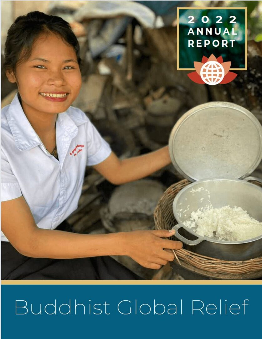A smiling girl prepares rice using a traditional stone grinder outdoors.