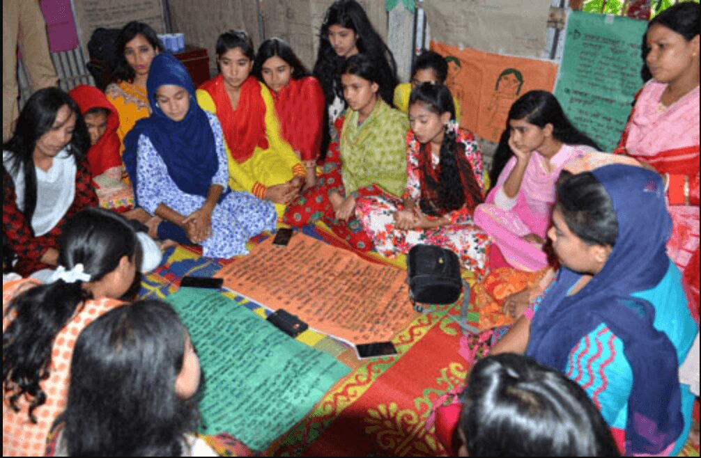Group of young girls gathered for a discussion or workshop.
