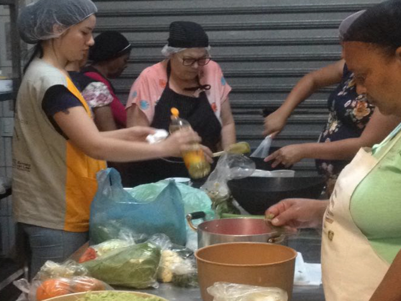 People preparing food together in a casual setting.