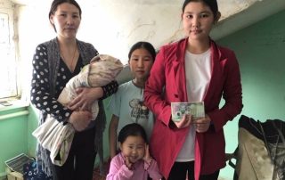A family with three women and two children inside a home.