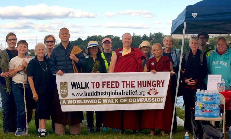 Group of people at a charity walk event outdoors.