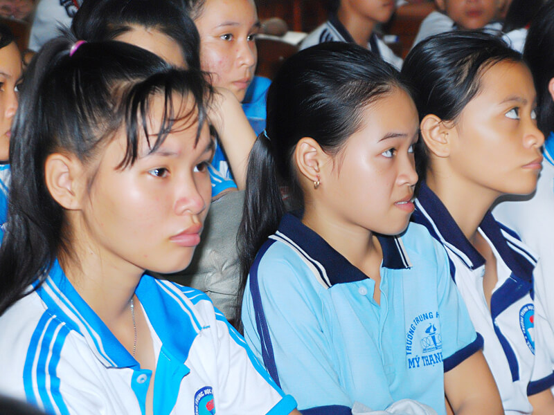 Young students attentively listening during a school event.