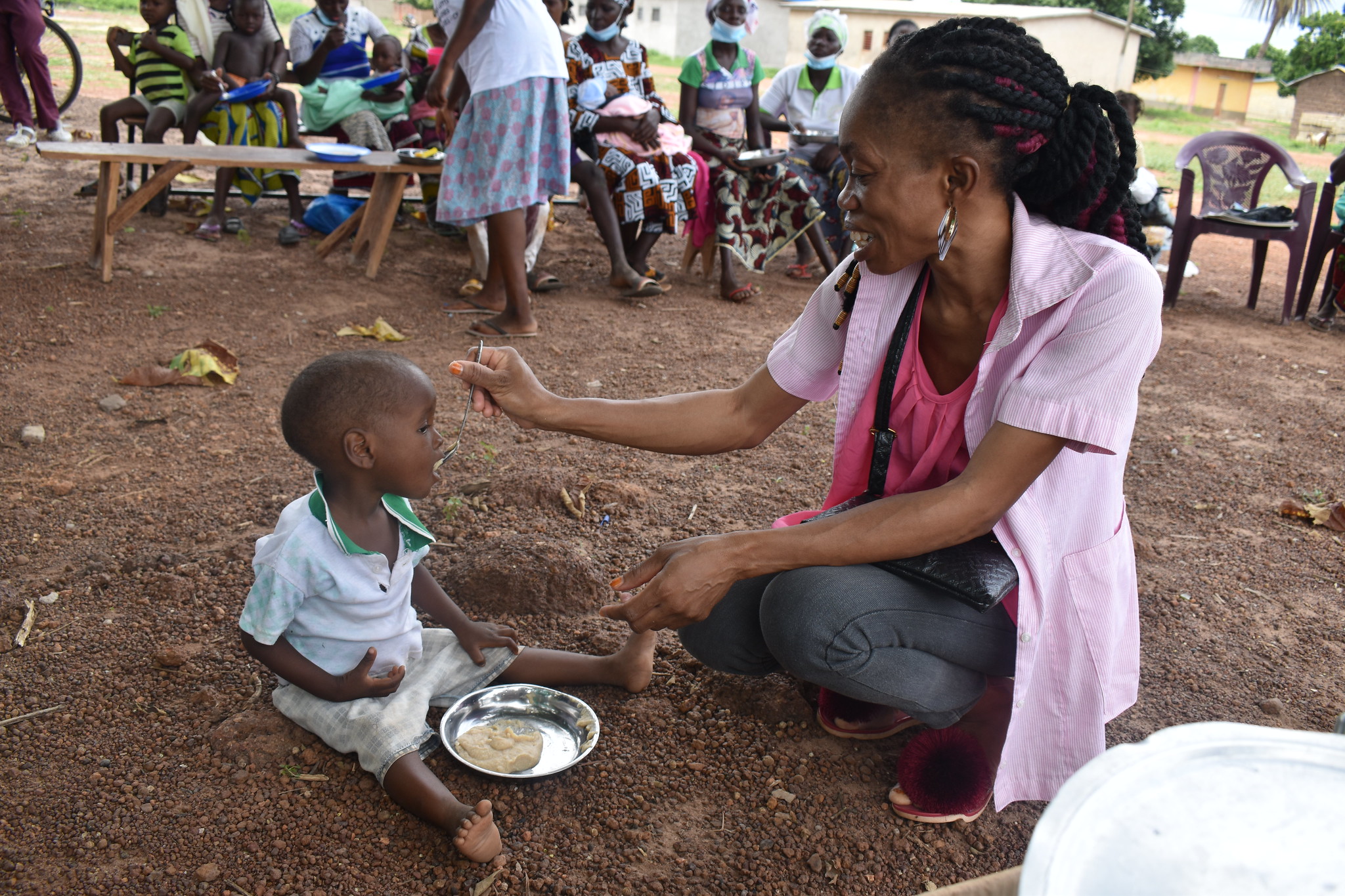 A midwife feeds a malnourished child at a site in northern Cote d'Ivoire.