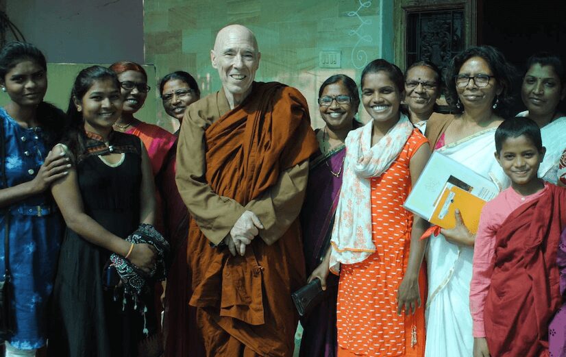 Group smiling with a monk in orange. Group smiling with a monk in orange.